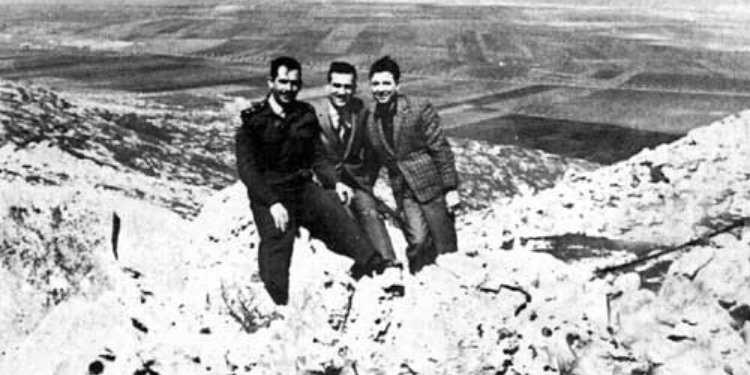 Eli Cohen and two other men stand with their arms around each other at the Golan Heights