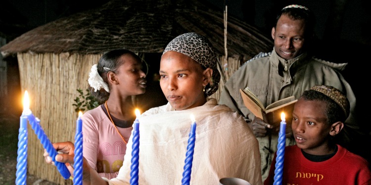 An Ethiopian family lighting the menorah.