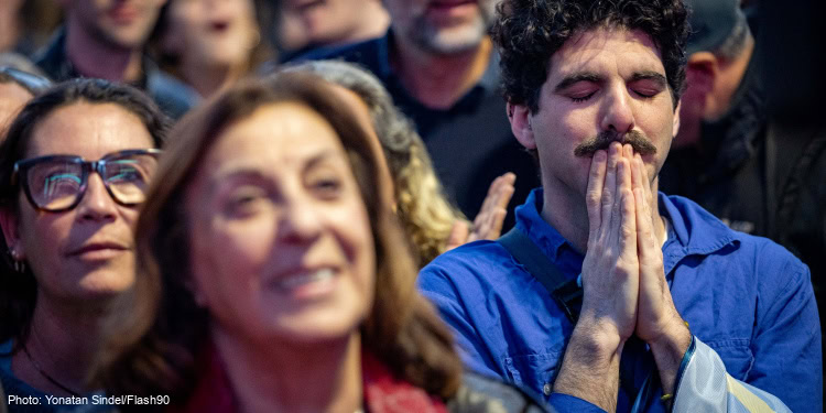 Israelis watch the release of three hostages from Hamas captivity as part of a deal between Israel and Hamas, at hostage square in Tel Aviv, January 19, 2025.