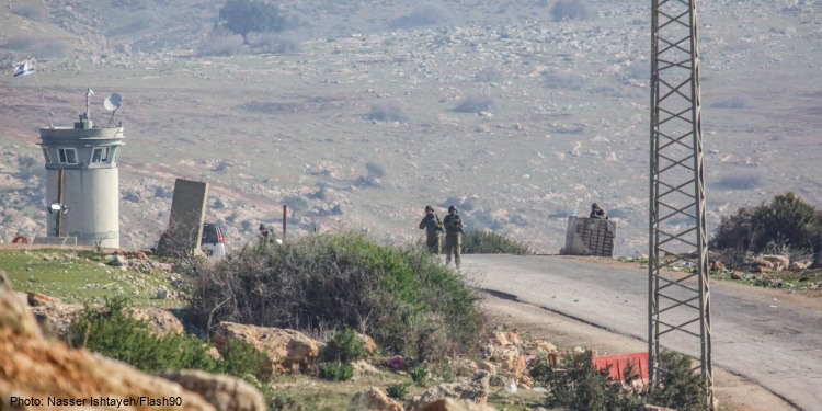 Israeli soldiers take positions at the scene of a shooting attack.