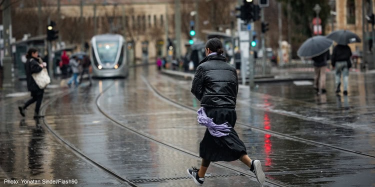 People walking in the rain on Jaffa street in Jerusalem, on February 5, 2025.