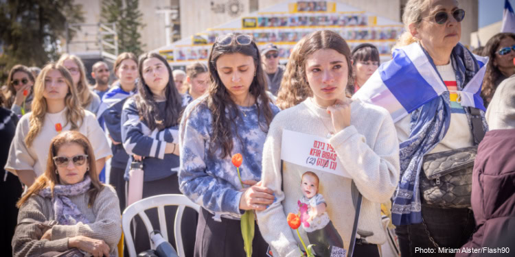 People gather to pay their respects during the funeral service of late Israeli hostages Shiri Bibas and her children Ariel and Kfir.