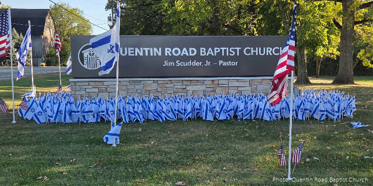 Flags of Fellowship event at Quiton Road Baptist Church in Lake Zurich, Illinois, October 2025. American flags - Israeli flags - planted on lawn - sign - "Quentin Road Baptist Church" - outdoors - daytime