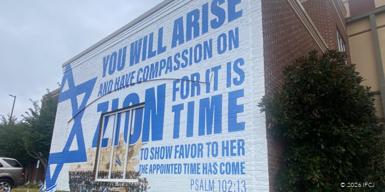 Large outdoor banner with a Star of David and message about compassion and support for the Jewish community.