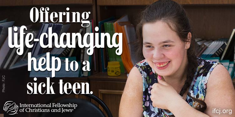IFCJ promotion featuring Darya, IFCJ disabled recipient who's laughing as she's sitting in a library.