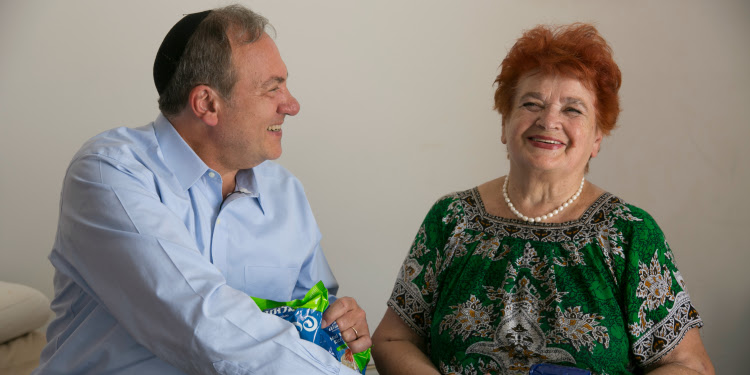 Rabbi Eckstein smiling with Kira, IFCJ recipient.