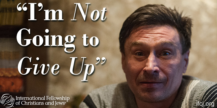 Evenij, a middle-aged man who's an IFCJ recipient featured in an IFCJ promotion with the text: I'm Not Going to Give Up.