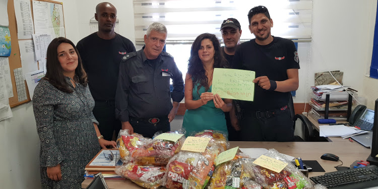 Firefighters receiving a gift package.