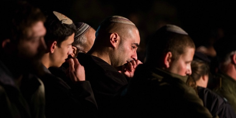 Several men with kippahs gathered together.