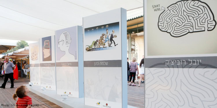 A young boy looks at an exhibition depicting thematic brain caricatures, organized by the Hebrew University, exhibited at the "First Station" in Jerusalem. July 11, 2013. Photo by Miriam Alster/FLASH90