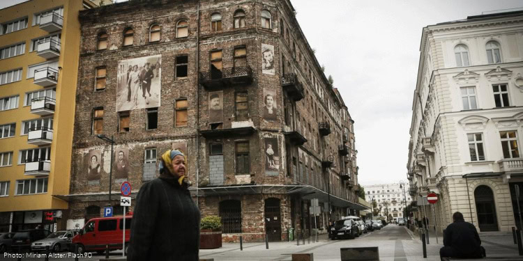 A woman walks past a building on Prozna Street in Warsaw, Poland. The street was located in the former Jewish quarters of Warsaw, and miraculously escaped Nazi destruction during World War II. September 24, 2013.