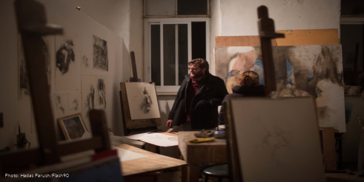 Visitors look at art work at the Master Art class in Beit Alliance, Jerusalem, on November 25, 2016.