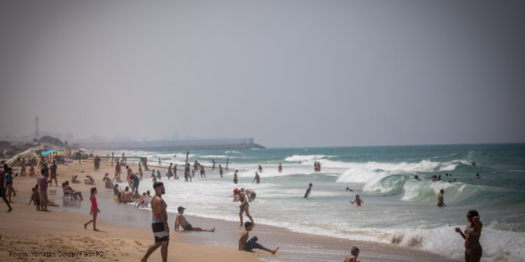 People enjoy at Zikim beach, southern Israel, on August 29, 2020.