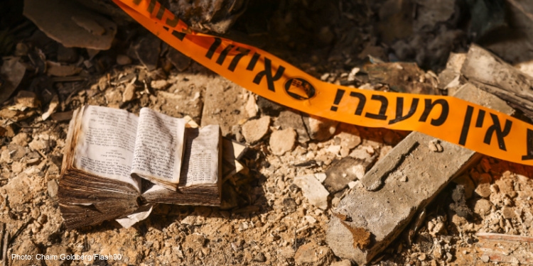 Destruction from the October 7 attack in Israel with religious textbook