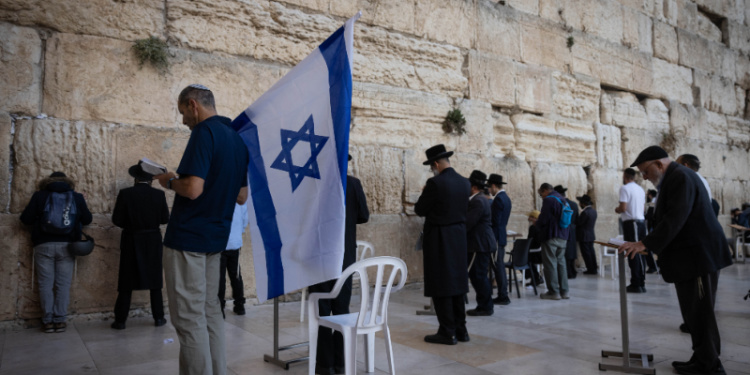 Men praying at the Western Wall in Jerusalem during the Israel War 2023