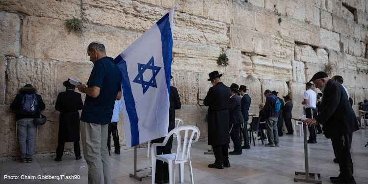 Men praying at the Western Wall in Jerusalem during the Israel War 2023