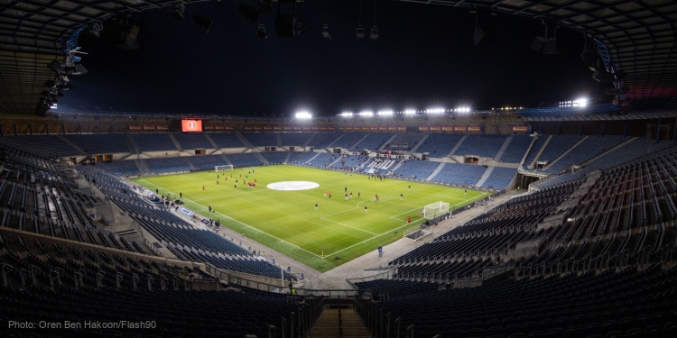 Israeli professional soccer field with players.