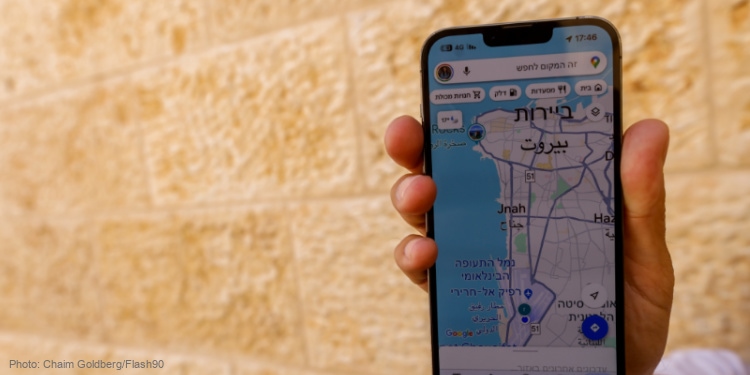 A man holds his phone showing his in Beirut at the Google Maps app, in Jerusalem, April 4, 2024.