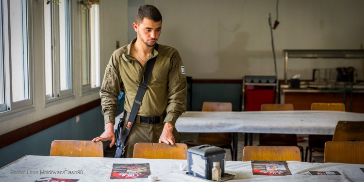 Israeli soldiers seen during a pre-Passover event for the return of Kibbutz Nir Oz hostages at the Kibbutz dining hall, near the Israeli border with the Gaza Strip, April 11, 2024. Photo by Liron Moldovan/Flash90