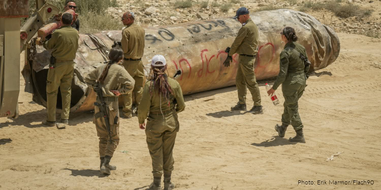 Israeli soldiers remove the remains of a missile fired from Iran a few weeks ago, near the southern Israeli city of Arad, May 2, 2024.