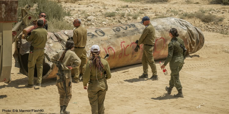 Israeli soldiers remove the remains of a missile fired from Iran a few weeks ago, near the southern Israeli city of Arad, May 2, 2024.