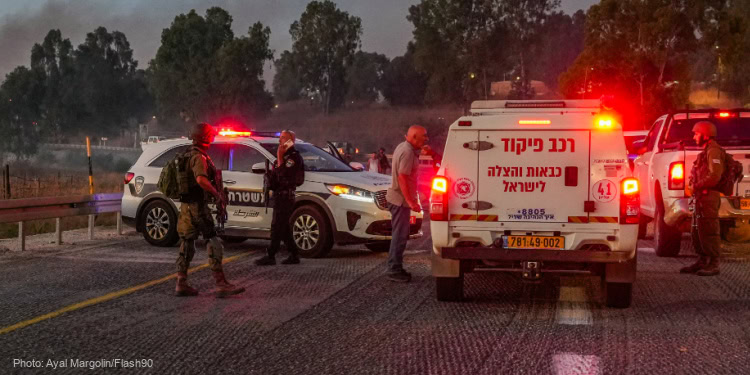 Security and rescue forces near the scene of where a rocket fired from Lebanon hit a car and critically injured two people near Nafah Junction, in the Golan Heights, July 9, 2024.