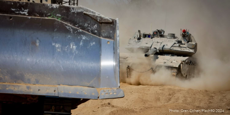 A military tank moving across a dusty desert landscape, kicking up a cloud of dust behind it.