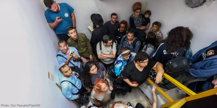 Israelis take cover inside a bomb shelter at the Ben Gurion airport as a siren alert is sounded in Tel Aviv, October 1, 2024. Photo by Dor Pazuelo/Flash90