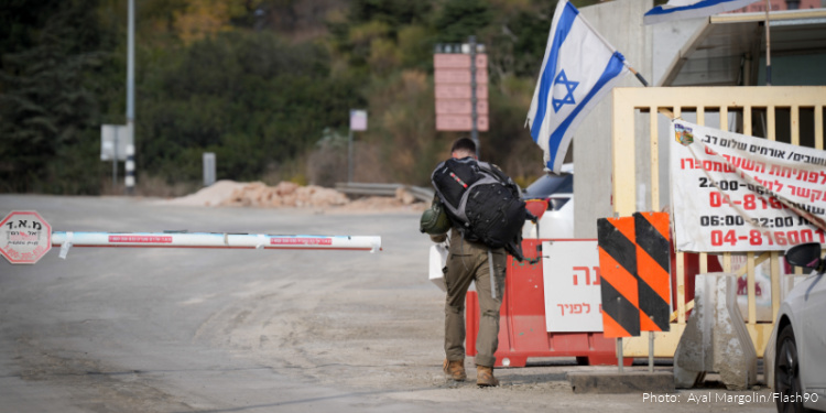 Metula, near the Israeli border with Lebanon, was hit by a rocket fired from Lebanon. One Israeli farmer and 4 foreign workers were killed when rockets crashed in agricultural field near border townOctober 31, 2024. Photo by Ayal Margolin/Flash90, soldier seen from behind at checkpoint, flags of Israel, border crossing