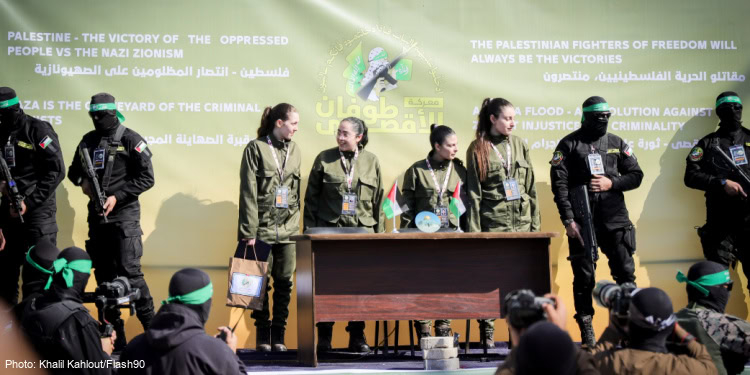 Al-Qassam Brigades, the military wing of Hamas, hand over four Israeli hostages to the Red Cross in Palestine Square, in Gaza City.