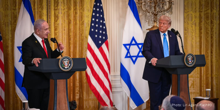 U.S. and Israeli leaders meet at a press conference to discuss peace efforts and cooperation, with flags of Israel and the United States displayed prominently behind them.