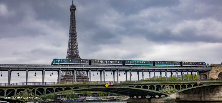 The metro is passing on a bridge near the Eiffel Tower in Paris, France, on April 13, 2025.