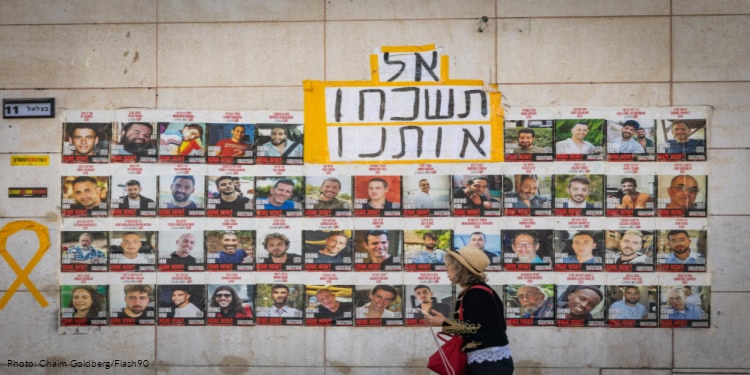 People walking next to pictures of Israelis held hostage by Hamas terrorists in Gaza, in Jerusalem, September 2, 2025