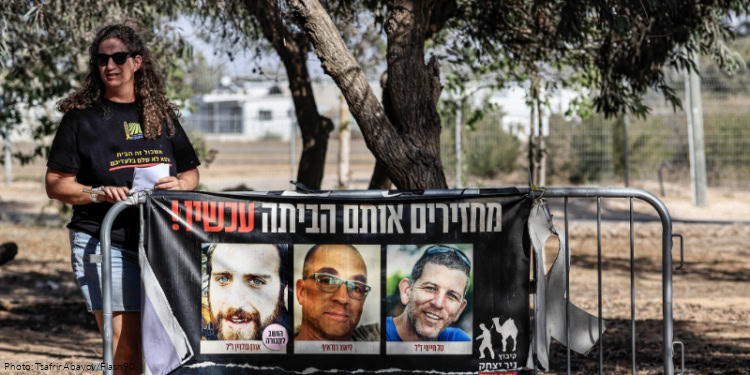 Ella Haimi, the wife of slain Israeli hostage Tal Haimi, whose body was returned overnight as part of a ceasefire agreement between Israel and Hamas, speaks to the media at Kibbutz Nir Yitzhak, in southern Israel, October 21, 2025.