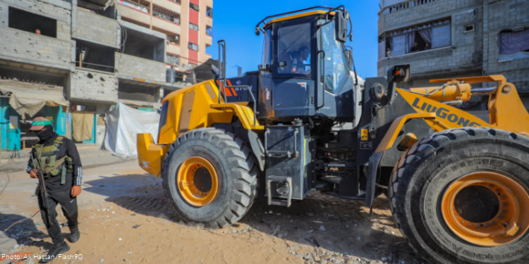 Members of the Qassam Brigades use heavy machinery to search for the bodies of Israeli hostages in the Nuseirat refugee camp in the central Gaza Strip, October 28, 2025