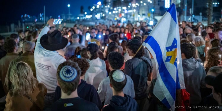 People light candles in memory of the victims of the mass shooting attack in Sydney targeting the Jewish community during Hanukkah celebrations, in Tel Aviv, on December 14, 2025.