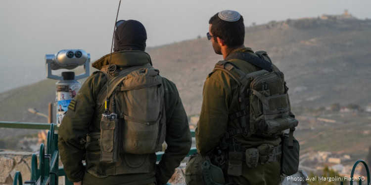 Israeli soldiers observe southern Lebanon from a lookout point near the Israeli border, January 25, 2026.