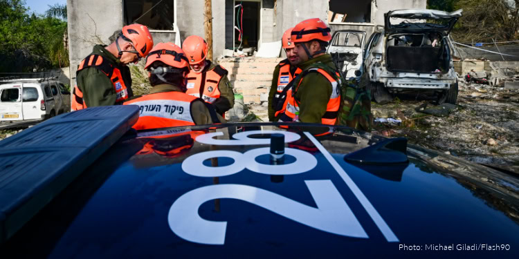 People look at the damage after a missile fired toward Israel overnight struck Zarzir, in northern Israel, March 13, 2026.