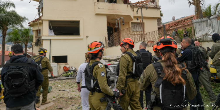 Military personnel and emergency responders at the scene of an attack in Iran.