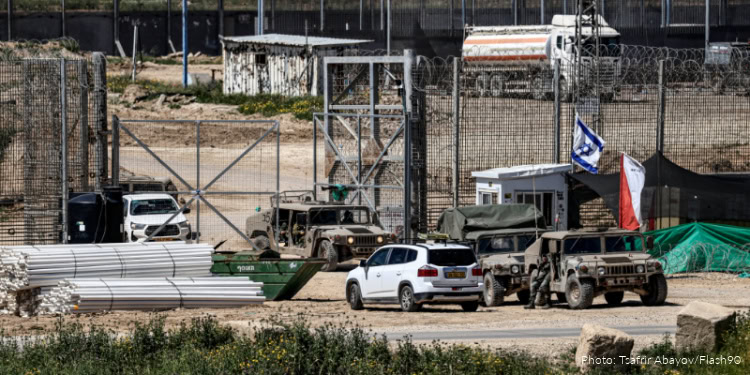Israeli military vehicles and equipment near a secure area, with flags and barriers, emphasizing ongoing efforts to disarm Hamas and ensure regional security.