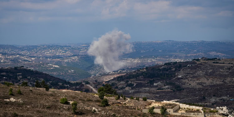 A large explosion in northern Israel with smoke rising over the landscape, indicating a recent incident in the region.