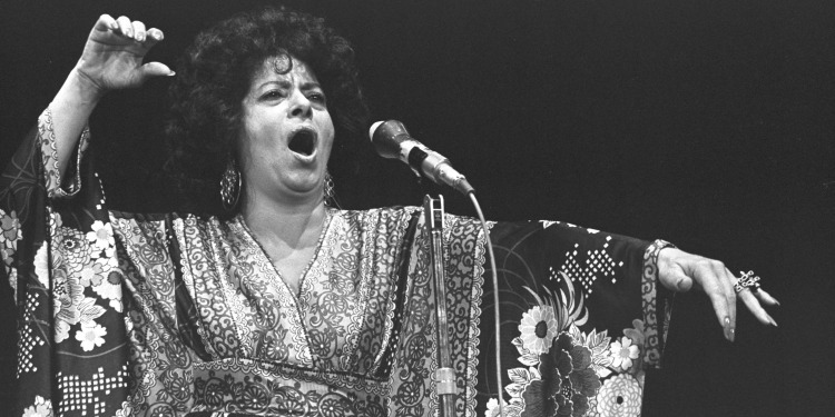 Black and white image of Shoshana Damari singing.