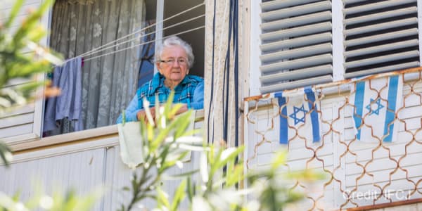 Fredirika, an elderly Auschwitz survivor looking out her window.