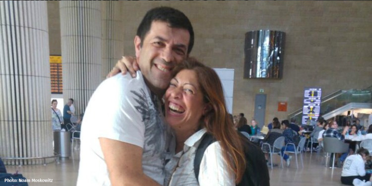 Couple hugging in the airport after Aliyah flight from Turkey.
