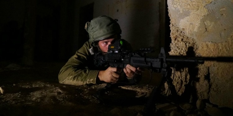 Soldier in ready position holding a weapon.