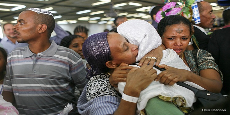 Two women embracing in a hug after making aliyah.