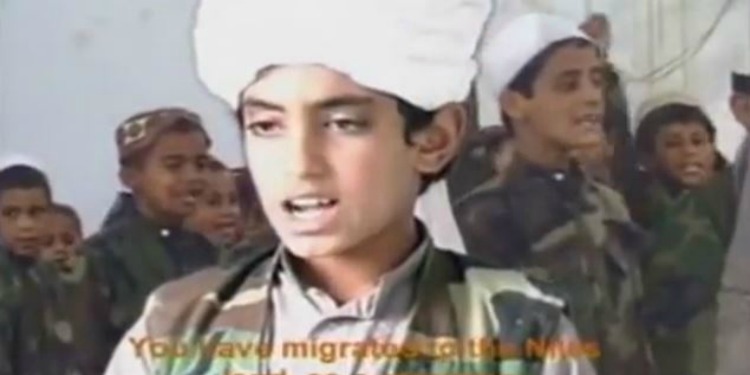 Screenshot of Hamza Bin Laden as a young boy with other young boys in uniform behind him.