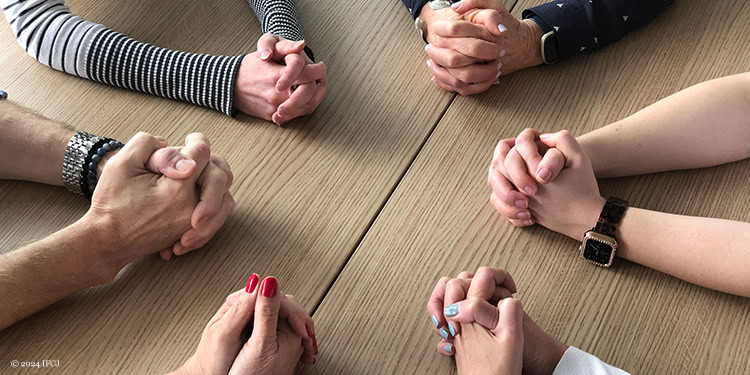 Hands around a table