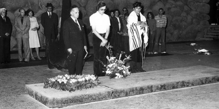 Black and white image of several gathered for a funeral.