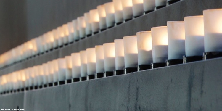 Two rows of white candles lit as a memorial for those who died in the Holocaust.